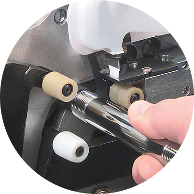 Hand inserting an unwrapped fitting into the Thred Taper machine.